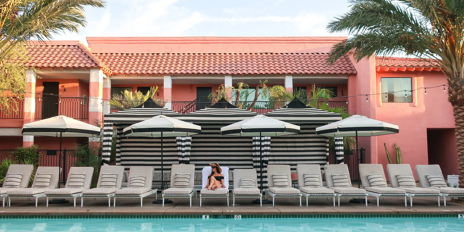 Sands Hotel pool with black and white umbrellas